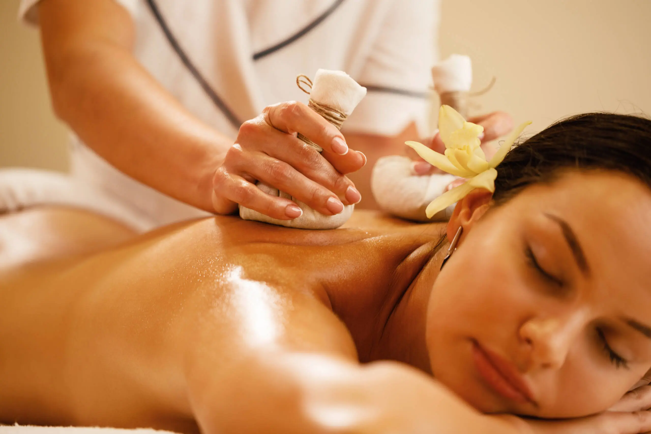 closeup-relaxed-woman-getting-back-massage-with-herbal-balls-health-spa-scaled